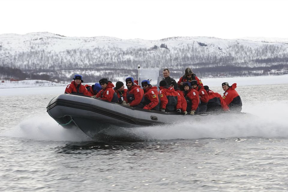 Group in boat rafting in Kirkenes
