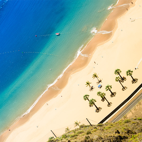 "Tenerife-beach-umbrellas-blue-sea"