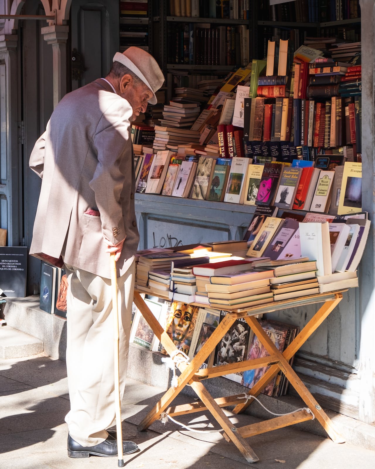 Elderly man looking at books in a stall