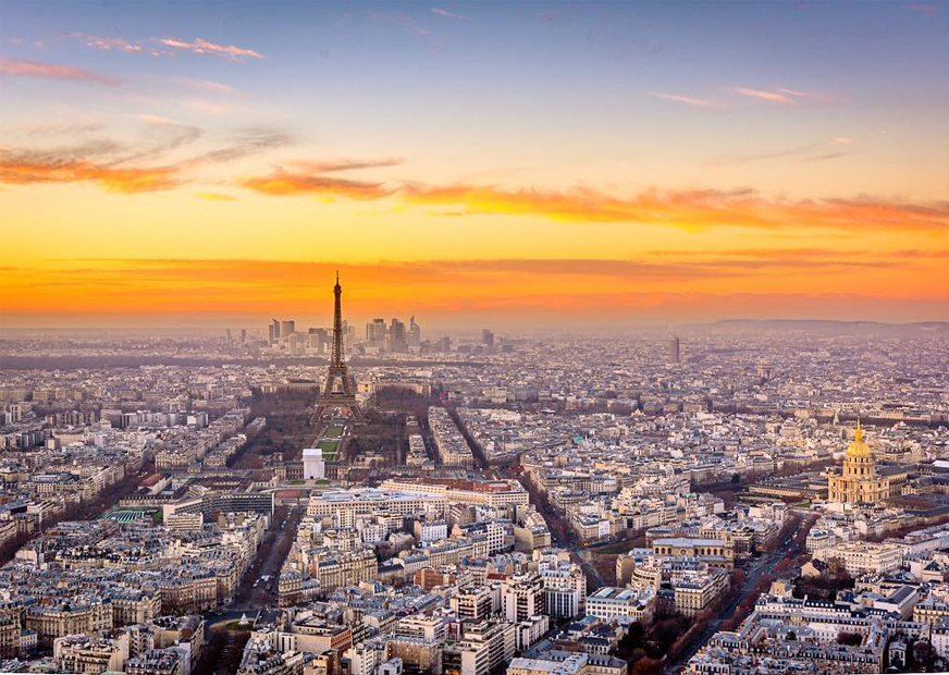 Paris seen from above with the Eiffel Tower dominating the picture. A beautiful sunset in the backdrop