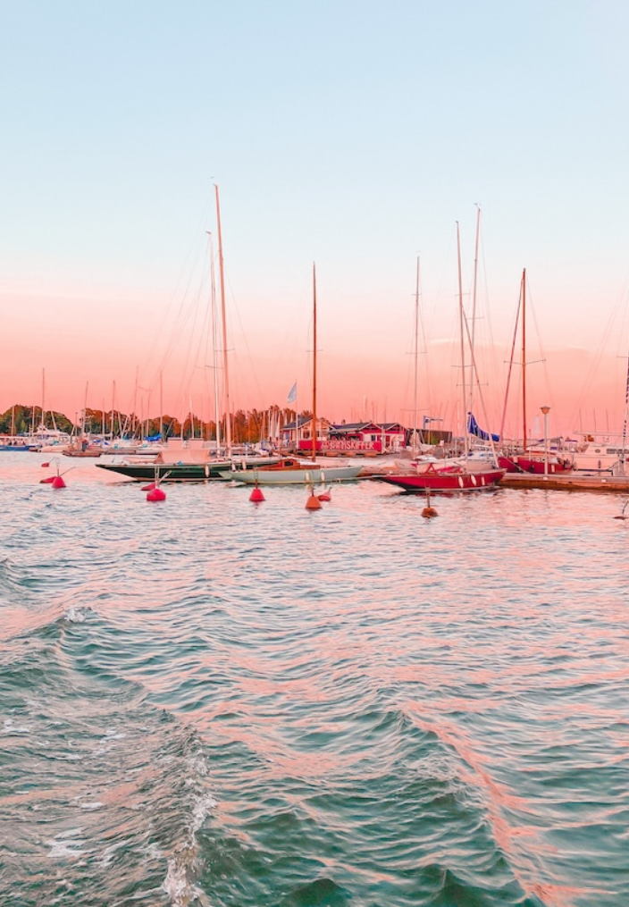 Sailboats and small island in pink light