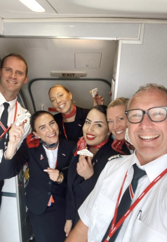 Cabin crew in uniforms taking a selfie 