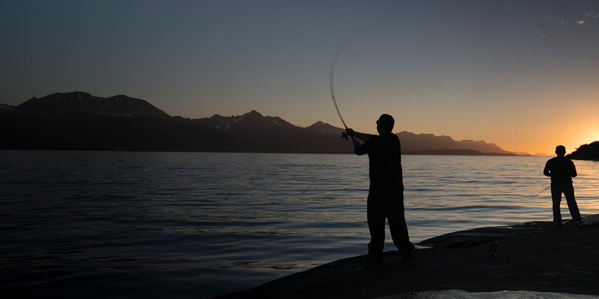 Man fishing under the midnight sun
