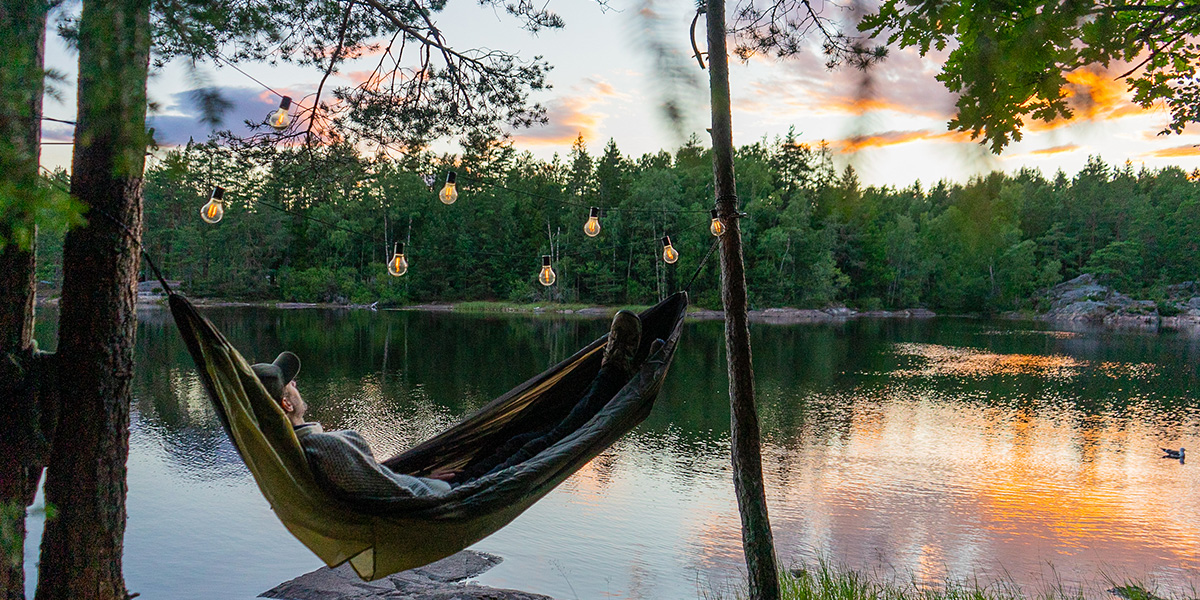 Man in hammock by the lake