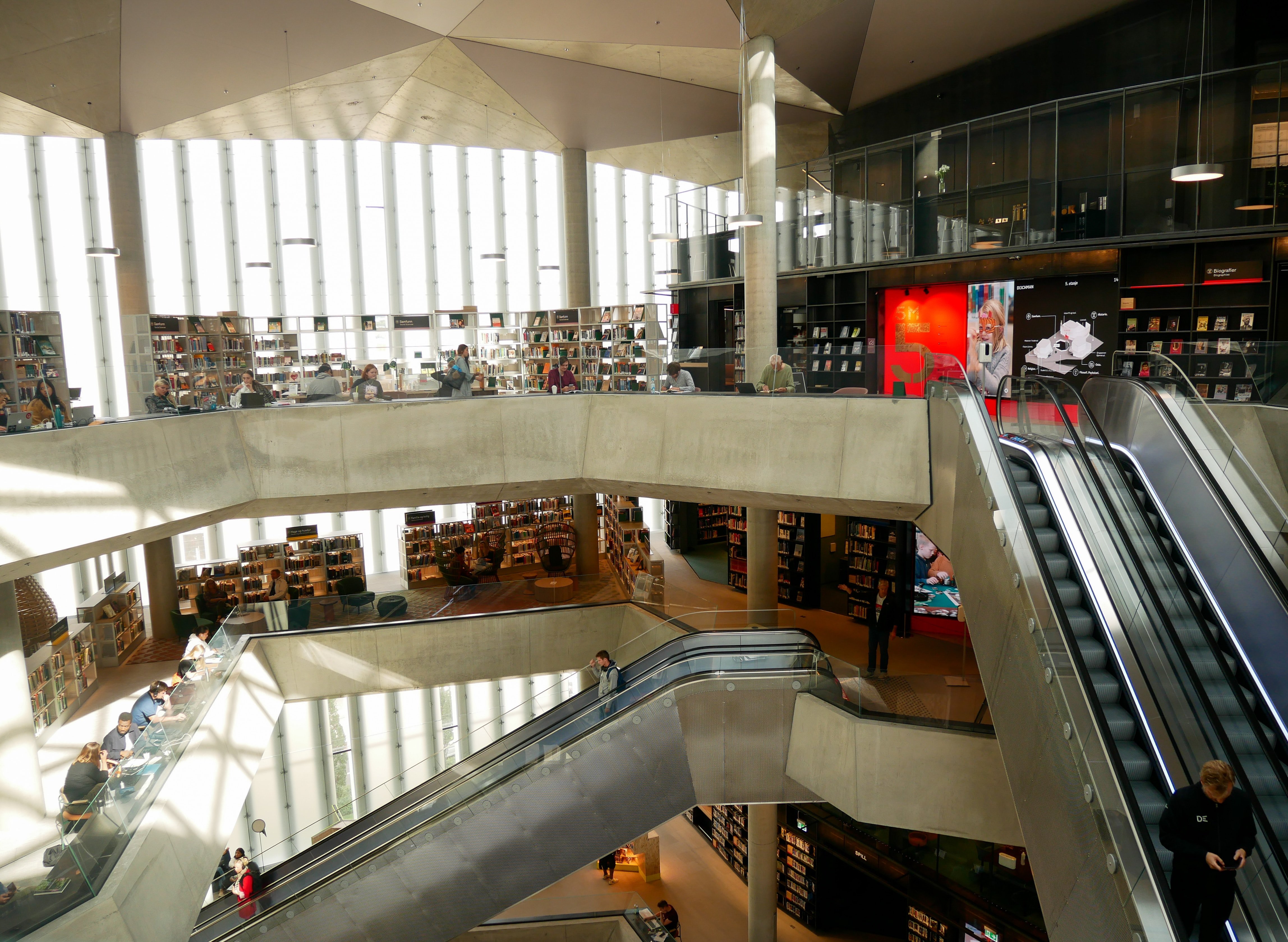 View from one of the upper floors looking downwards. The lighting is soft, and there is a calm atmosphere.
