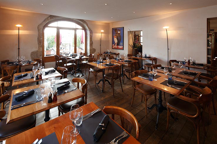 Fly to Geneva, dine at Café des Negociants.